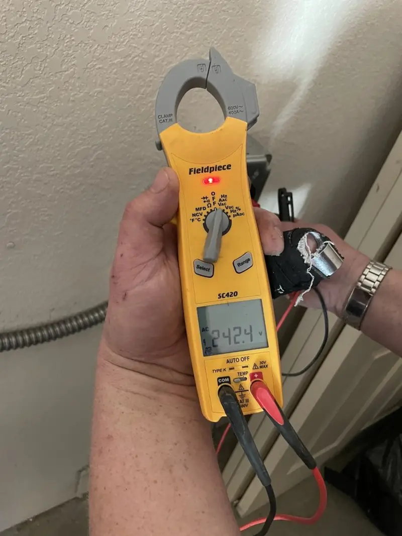 Voltage testing with clamp meter during Outlet Installation in Winder